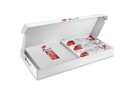 Selection of Marcial Ibérico half pieces and sliced products served on a platemontanera en el encinar de poniente marcial